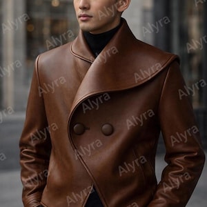 May include: A brown leather jacket featuring a wide, folded shawl collar, long sleeves, and a double-breasted front closure with two large, matching circular buttons. The jacket is worn over a black high-neck garment and dark trousers.