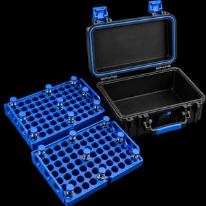 May include: A black protective hard-shell carrying case with blue latches and a blue interior seal, accompanied by two blue plastic storage trays featuring multiple circular slots, some of which contain small clear glass vials with blue caps.
