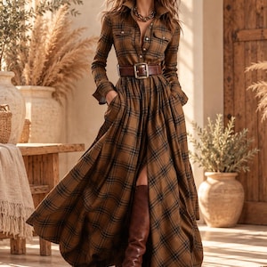 May include: A long-sleeved, floor-length brown plaid shirt dress featuring a button-down front, a pointed collar, two chest pockets, and a wide dark brown leather belt with a large rectangular buckle. The dress has a full, pleated skirt.
