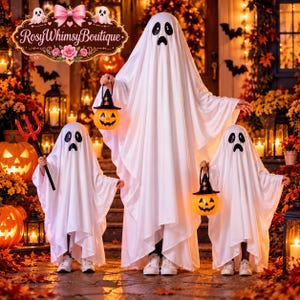 May include: Three white ghost costumes made of draped fabric with black oval eyes and mouth cutouts. The costumes feature long, flowing sleeves and hem lines. Two costumes hold orange plastic jack-o'-lantern buckets with black hats.