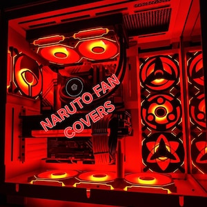 May include: A computer case interior illuminated by bright red LED lighting, featuring custom fan covers with Naruto-inspired designs. The setup includes multiple cooling fans, internal components, and the text NARUTO FAN COVERS displayed prominently.