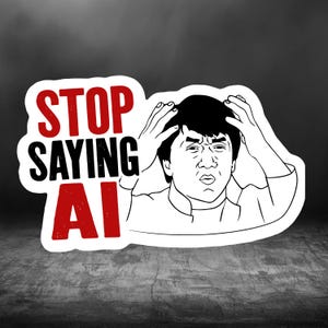 May include: A die-cut sticker featuring a black and white line art illustration of a person holding their head in frustration. The text STOP SAYING AI is printed in bold red and black capital letters to the left of the illustration.