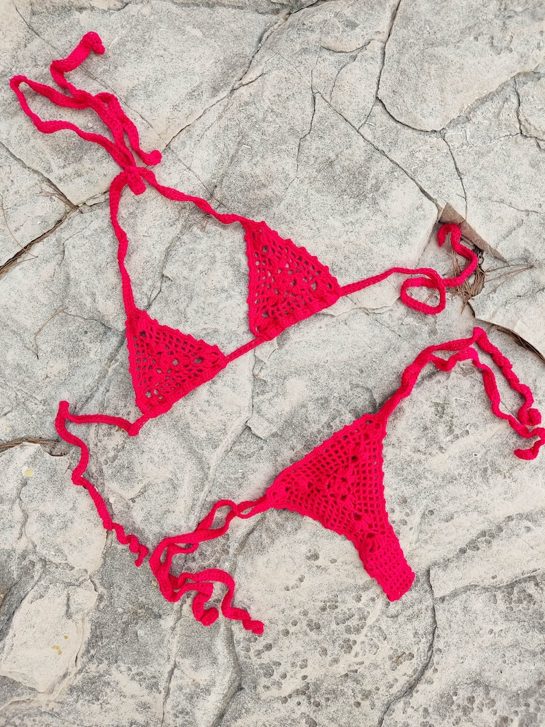 May include: A handmade, wooden serving tray with a natural finish. The tray features a rectangular shape with rounded corners and raised edges. It is designed with two integrated handles for easy carrying. The wood grain is visible throughout the tray.