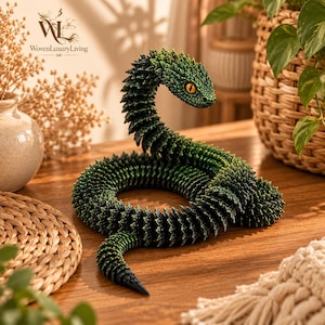 May include: A coiled, articulated snake figurine featuring a textured, scale-like surface in shades of dark green and black. The snake has a raised head with prominent, bright yellow eyes and a black pupil, showcasing a segmented, flexible design.