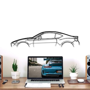 May include: A black metal wall art piece featuring the minimalist outline of a sports car in profile. The design captures the sleek silhouette of the vehicle, including the hood, roofline, windows, and wheel arches, rendered in a single continuous line.