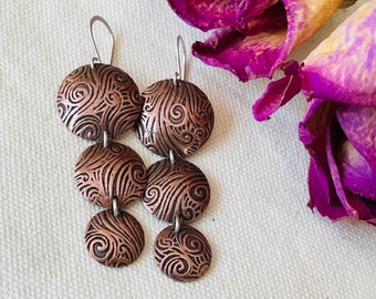 Long, domed copper and silver earrings - swirly handmade dangle earrings