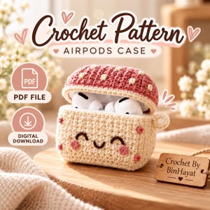 May include: A crochet pattern for an AirPods case, featuring a mushroom-shaped cover in pink with white dots and a cream-colored base with a smiling face. The text reads Crochet Pattern AIRPODS CASE, PDF FILE, DIGITAL DOWNLOAD, and Crochet By BinHayat.