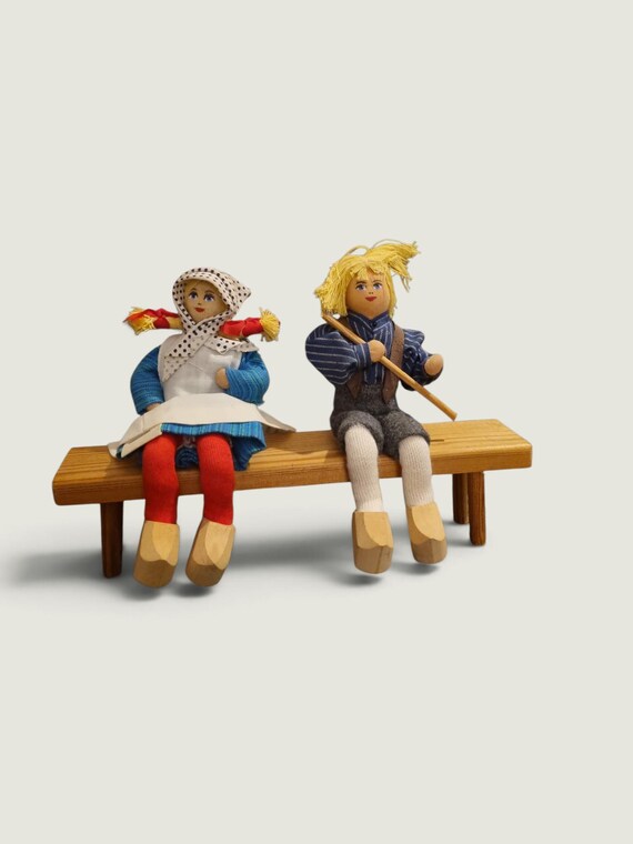 Charlotte Weibull Traditional Folk Dolls Sitting On A Bench