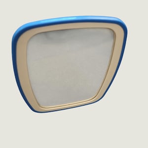 May include: A handheld mirror with a rounded square shape, featuring a bright blue outer frame and a cream-coloured inner border surrounding the reflective glass surface. The mirror has a smooth, clean finish and a simple, functional design.