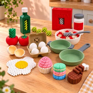 May include: A toy food set featuring a green bottle, red tomatoes with green tops, a brown egg carton with four white eggs, two broken egg shells, a red pasta box, a white sauce jar, a white bowl with pasta, two green pans, a fried egg, a pink cupcake, colorful macarons, and a brown meat piece.