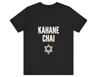 May include: A black short-sleeved t-shirt featuring the white text KAHANE CHAI printed in a bold, sans-serif font. Below the text is a beige-colored Star of David symbol with a subtle three-dimensional shadow effect.