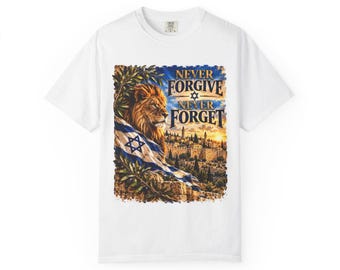 May include: A white t-shirt featuring a graphic print of a lion draped in an Israeli flag, positioned next to an ancient city skyline at sunset. The text "NEVER FORGIVE NEVER FORGET" with a Star of David is printed in gold above the lion illustration.