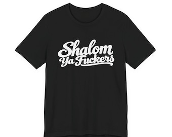 May include: A black short-sleeved t-shirt featuring white cursive text printed on the chest that reads Shalom Ya Fuckers. The garment has a standard crew neckline and a straight hemline, presented against a plain white background.