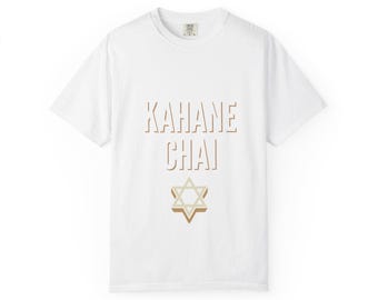 May include: A white short-sleeve t-shirt featuring the text KAHANE CHAI in a light brown, outlined font centered on the chest. Below the text is a graphic of a Star of David rendered in shades of light brown and beige with a 3D effect.