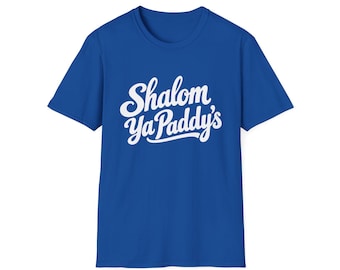 May include: A royal blue short-sleeved t-shirt featuring the white text "Shalom Ya Paddy's" printed in a cursive script font across the center of the chest. The garment has a crew neckline and a standard fit with short sleeves.