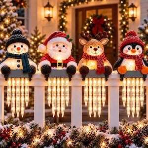 May include: Four illuminated Christmas fence toppers featuring a snowman, Santa Claus, a reindeer, and a penguin. Each character wears a winter hat and scarf, and is attached to a base with hanging, glowing icicle-shaped LED light strands.