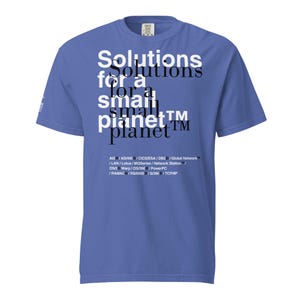 May include: A periwinkle blue short-sleeve t-shirt featuring white and black text that reads Solutions for a small planet, followed by a list of technical terms including AIX, AS/400, CICS/ESA, DB2, Global Network, LAN, Lotus, MQSeries, and others.