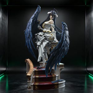 May include: A detailed anime-style figurine of a character with long black hair, horns, and large dark blue feathered wings. The figure wears a white dress with gold accents, holds a dark goblet, and sits on a staircase with a red carpet runner.