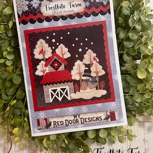 May include: A decorative craft pattern titled "Frostbite Farm" with a winter scene. The design features a red barn, snow-covered trees, and a snowman. The finished size is 12" x 12". The text "My Red Door Designs" is also visible.