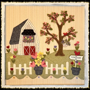 Peut inclure: Une décoration murale en tissu appliqué encadrée représentant une grange blanche aux portes rouges, un arbre aux fleurs roses, une clôture blanche et des fleurs en pot. Un panneau indique FLOWER BARN. La scène inclut des oiseaux rouges.