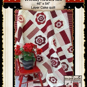 May include: A red, white, and cream quilt with a floral pattern. The quilt is 46 inches by 54 inches and is called "Whimsy Flowers Two". It is a layer cake quilt.