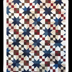 May include: A quilt with a repeating pattern of blue stars on a white background. The stars are surrounded by squares of red, brown, and beige fabric.