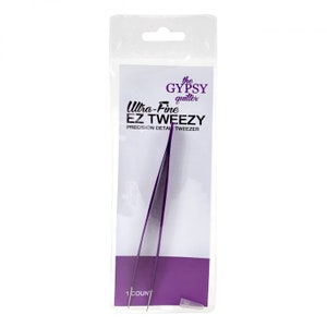 May include: Purple Ultra-Fine EZ Tweezy Precision Detail Tweezer by The Gypsy Quilter. The tweezer is packaged in a clear plastic bag with a purple background.