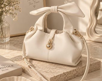 Ivory Bow handbag - elegant cream shoulder bag with gold charm & adjustable strap