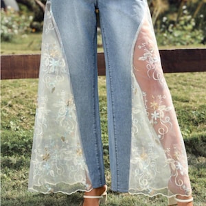 Handmade lace panel jeans transforming original denim into custom flare pants, artistic upcycled fashion piece with boho aesthetic