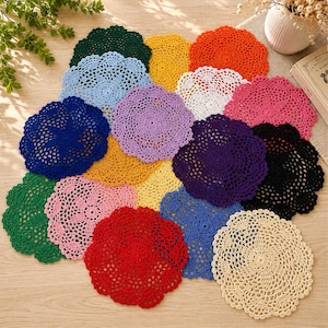 May include: A collection of round, crocheted lace doilies in a variety of vibrant colors including red, orange, yellow, green, blue, purple, pink, black, white, and cream. Each doily features an intricate, openwork floral or star-like pattern.