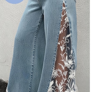 Boho lace flare jeans with floral lace details, custom upcycled denim pants styled as festival outfit statement clothing for women