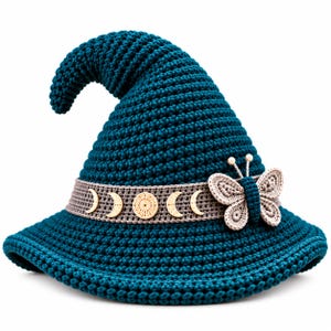 May include: A dark teal crocheted pointed hat featuring a wide beige band decorated with wooden moon phase charms and a beige crocheted butterfly embellishment with two small white beads at the top of the antennae on the front.