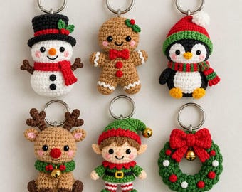 May include: A set of six crochet keychains featuring holiday characters including a snowman with a black hat, a gingerbread person, a penguin in a red hat, a reindeer with a gold bell, an elf, and a green wreath with a red bow and gold bell.