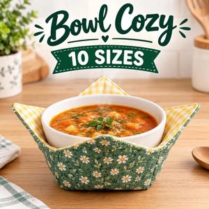May include: A quilted fabric bowl cozy featuring a green exterior with a white daisy pattern and a yellow and white gingham interior. The cozy holds a white ceramic bowl filled with vegetable soup. Text reads Bowl Cozy 10 SIZES.