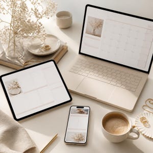 May include: A laptop, tablet, and smartphone displaying a digital planner with a calendar and task lists. A ceramic mug with coffee, a glass vase with dried flowers, a small candle, and gold rings are arranged on a neutral-toned surface.