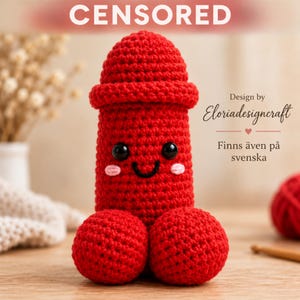 May include: A red crochet plush toy featuring a phallic shape with a rounded top, two spherical base sections, and a smiling face with black bead eyes and pink stitched cheeks. The text "Design by Eloriadesigncraft" is visible on the right.