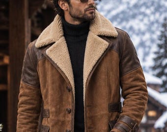 May include: A brown suede coat featuring a tan shearling collar, dark brown leather shoulder panels, and matching leather pocket flaps. The coat includes button closures, buckled sleeve straps, and a long silhouette worn over a black turtleneck.