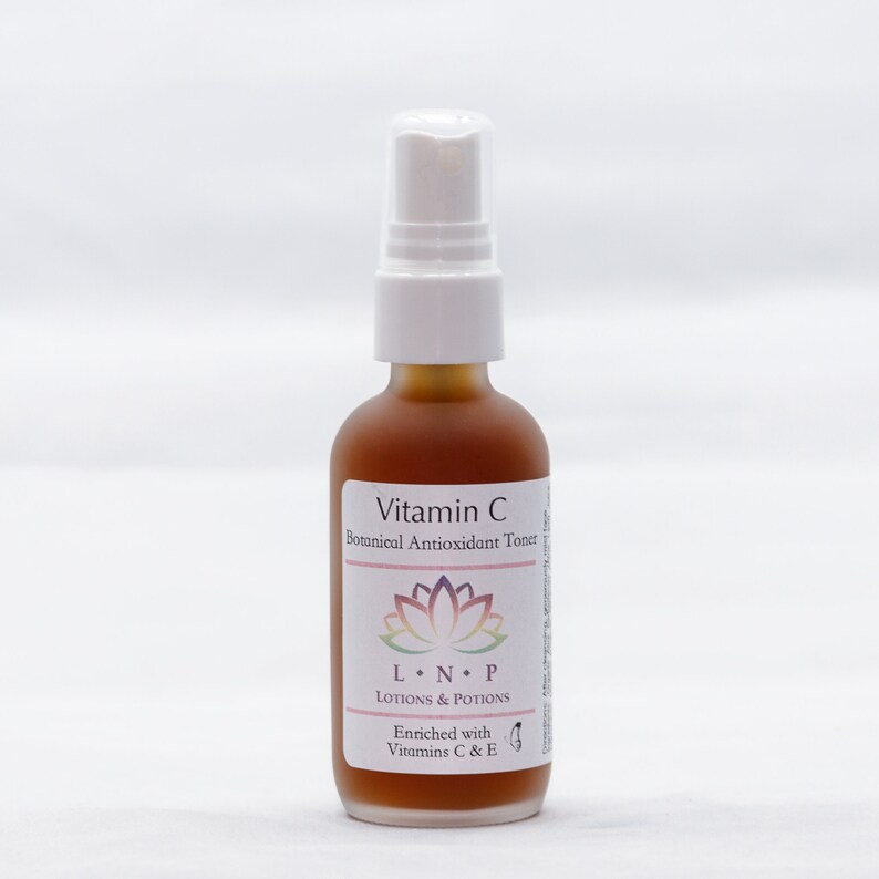 May include: A brown glass bottle with a white spray top. The bottle is labeled "Vitamin C Botanical Antioxidant Toner" and "LNP Lotions & Potions". The label also says "Enriched with Vitamins C & E".