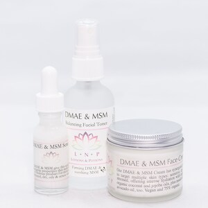 May include: Three white bottles of skincare products with silver lids. The bottles are labeled "DMAE & MSM" and "L.N.P. LOTIONS & POTIONS". The products are a serum, toner, and face cream.