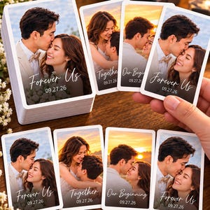 May include: A deck of custom playing cards featuring a romantic couple at sunset. Each card displays a photograph of the pair with the text Forever Us, Together, or Our Beginning, along with the date 09.27.26 printed in a white script font.