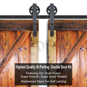May include: A black bi-parting double door kit with two wooden doors, featuring a black track and black metal rollers. The text on the image reads: "Highest Quality Bi-Parting Double Door Kit Featuring Our 'Hush Puppy' Super Smooth, Super Quiet Wheels! Rubberized Stops For Soft Landing"