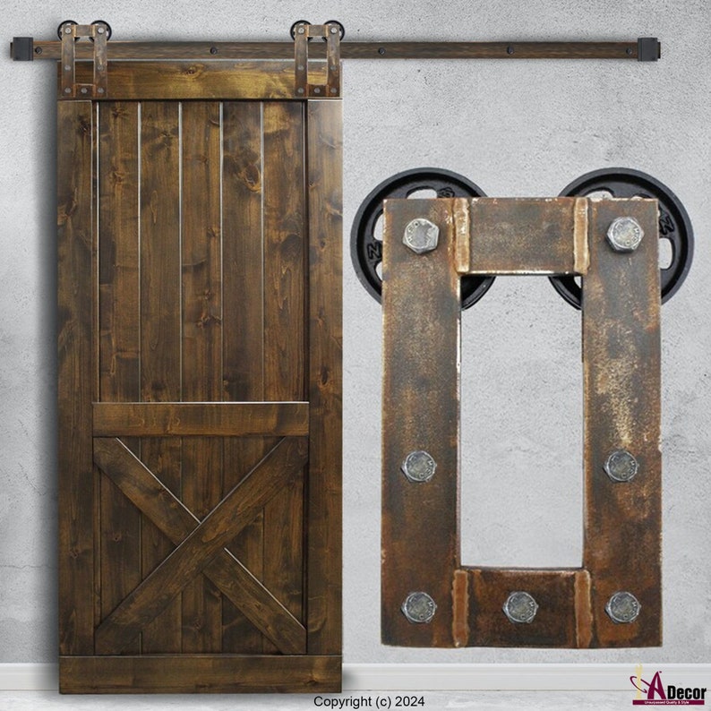 May include: A dark brown wooden sliding barn door with vertical planks and a lower X-brace design, featuring a black metal top rail and rollers. Beside it is a rectangular metal mounting plate with six visible bolts and two black wheels.