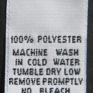 May include: White care label with black text that reads "100% Polyester, Machine Wash in Cold Water, Tumble Dry Low, Remove Promptly, No Bleach, Made in U.S.A."