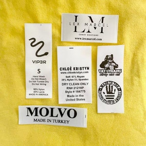 May include: A collection of clothing labels with various brand names, sizes, and care instructions. The labels include "Viper", "Lex Marcel", "Chloe Kristyn", "Fat Straps", and "Molvo".