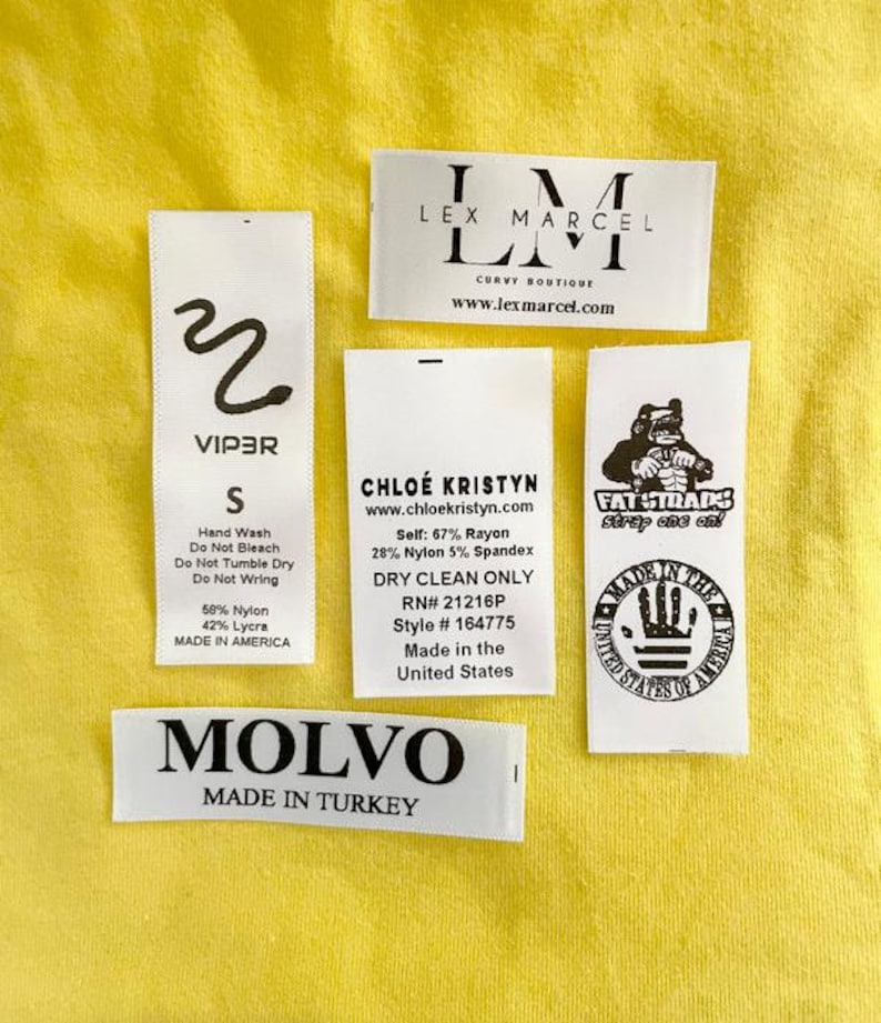 May include: A collection of clothing labels with various brand names, sizes, and care instructions. The labels include "Viper", "Lex Marcel", "Chloe Kristyn", "Fat Straps", and "Molvo".