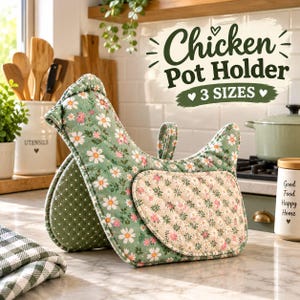 May include: A chicken-shaped pot holder featuring a green fabric with a white and pink daisy floral pattern. The side panel has a quilted texture with a smaller floral print, and the interior is a dark green fabric with white polka dots.