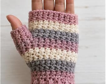 May include: A fingerless glove featuring a ribbed cuff and horizontal stripes in dusty rose, cream, and grey yarn. The crochet texture is visible throughout the piece. The text Front View is printed in the upper right corner of the image.