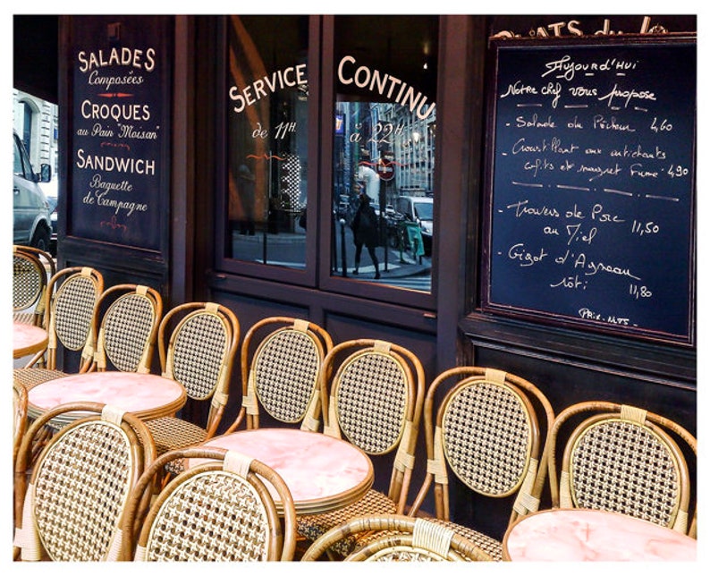 Paris cafe photography print with bistro chairs and marble tables.
