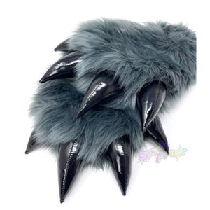 May include: A pair of gray furry hand warmers with black claws. The claws are made of a shiny material and are pointed.