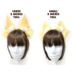 May include: Two pairs of faux fur cat ears, one pair is 5 inches tall and the other is 3 inches tall. Both pairs are yellow with white tips.